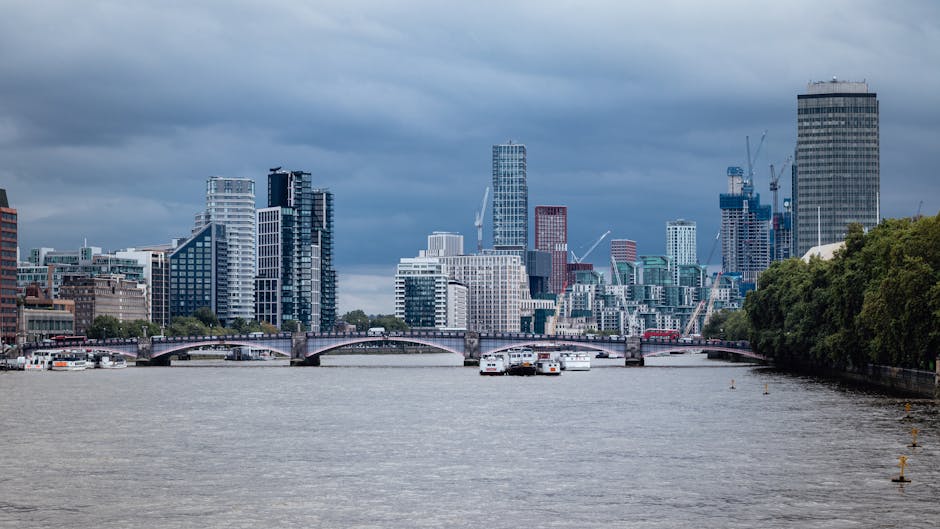 A large observation wheel, known as the London Eye, is prominently displayed in the image, with its white-painted steel structure supporting numerous enclosed passenger capsules arranged along its cir